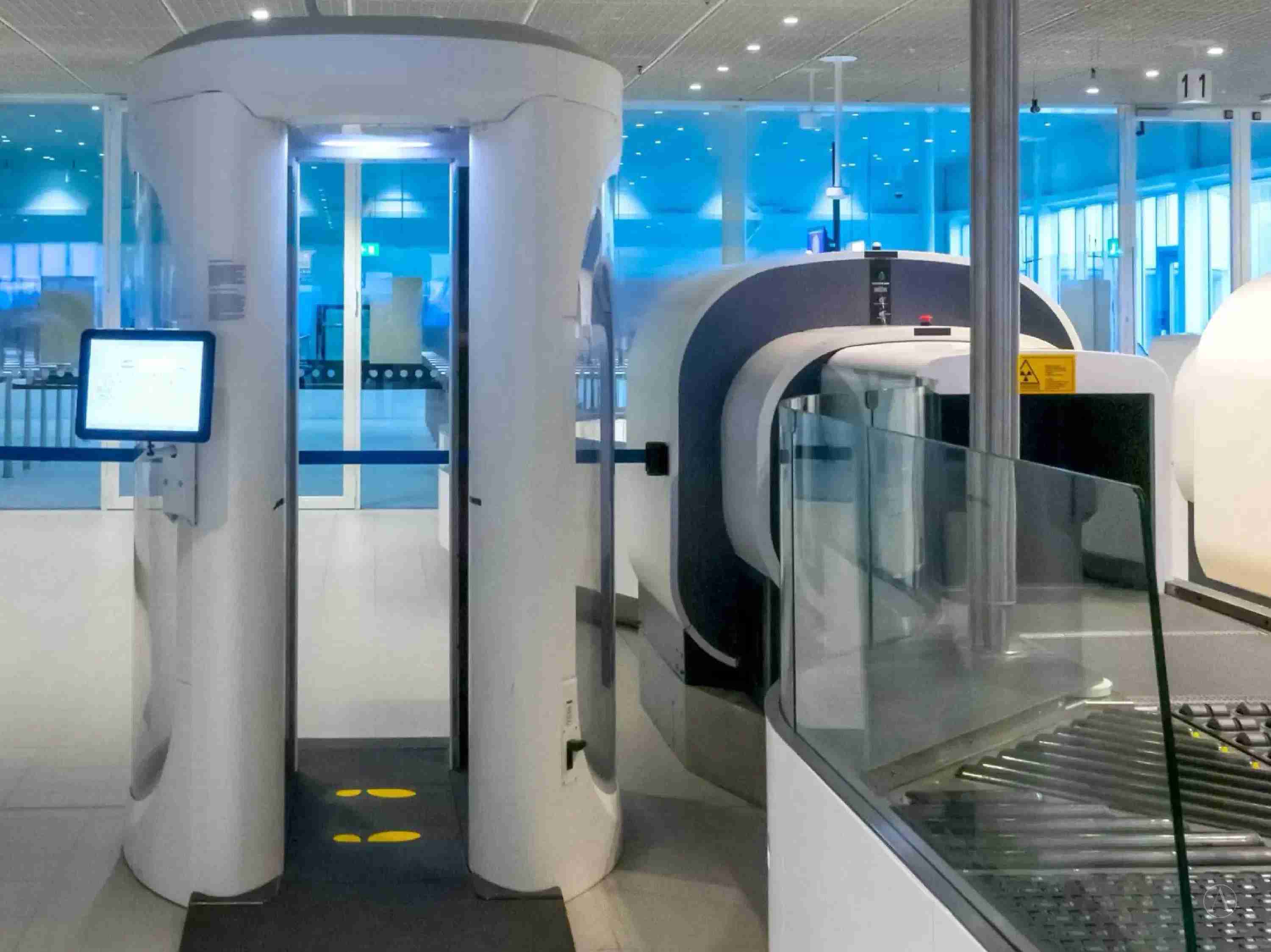 Photograph of an airport CT scanner.